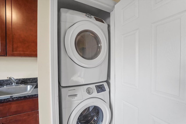 laundry room with a sink, laundry area, and stacked washing maching and dryer