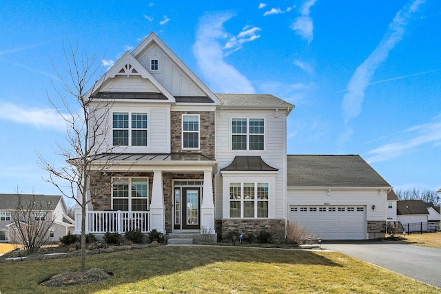 craftsman inspired home with board and batten siding, aphalt driveway, covered porch, stone siding, and a standing seam roof