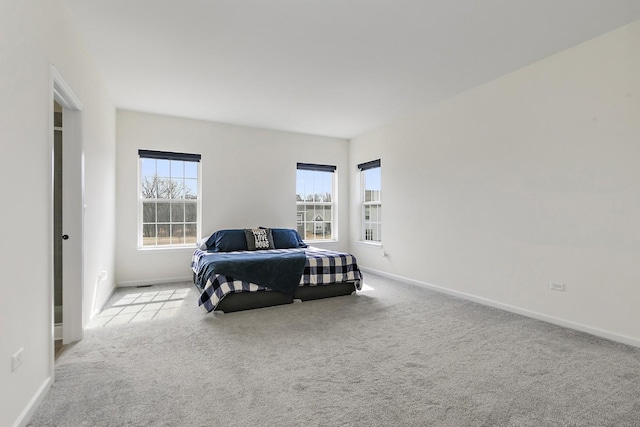 carpeted bedroom featuring baseboards