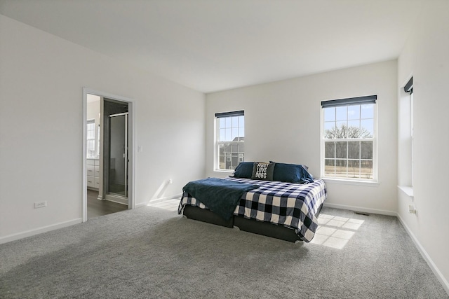 bedroom featuring ensuite bath, carpet, baseboards, and visible vents