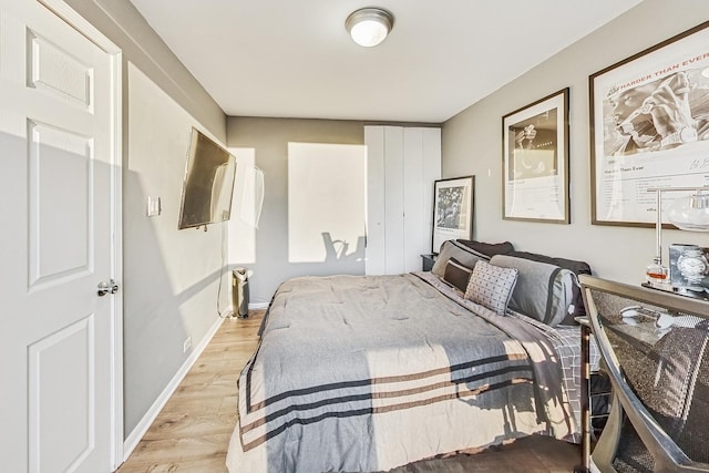 bedroom with baseboards and light wood-style flooring