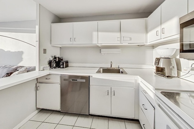 kitchen with white cabinets, appliances with stainless steel finishes, light countertops, and a sink