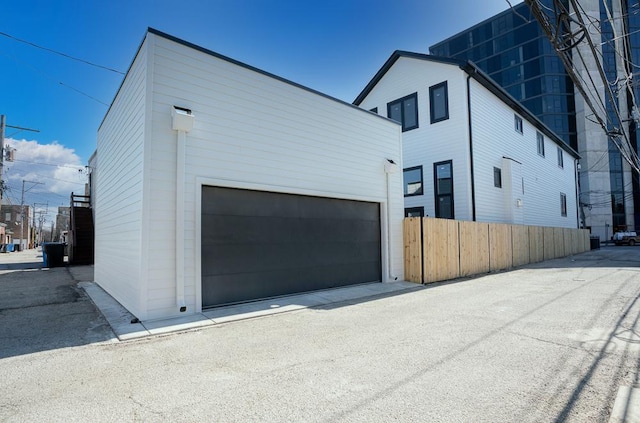 exterior space featuring an outdoor structure, a garage, and fence