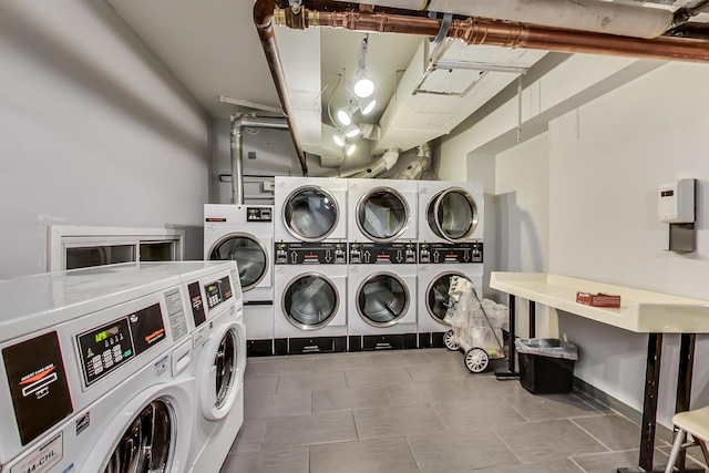 community laundry room featuring stacked washer / drying machine, independent washer and dryer, and tile patterned flooring