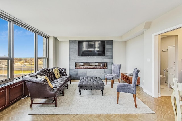 living room featuring a fireplace and baseboards