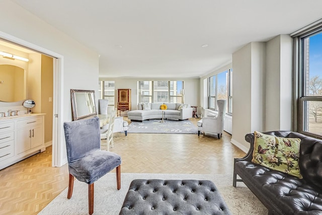 living area featuring baseboards