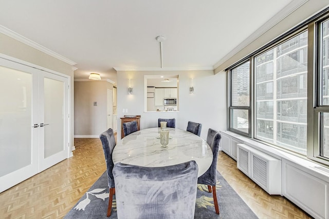 dining room with french doors, baseboards, and ornamental molding