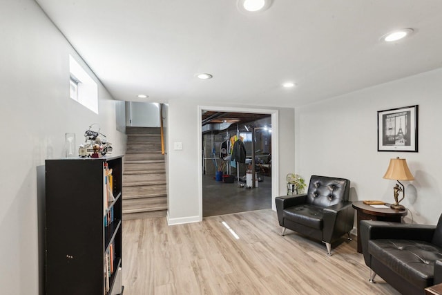 living area with light wood finished floors, recessed lighting, stairs, and baseboards