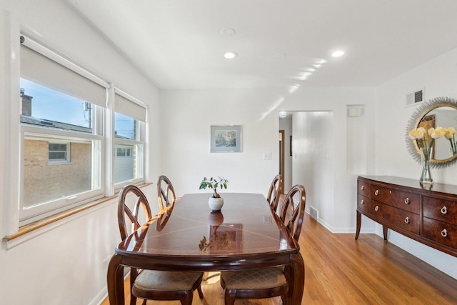 dining room featuring recessed lighting, baseboards, visible vents, and light wood finished floors