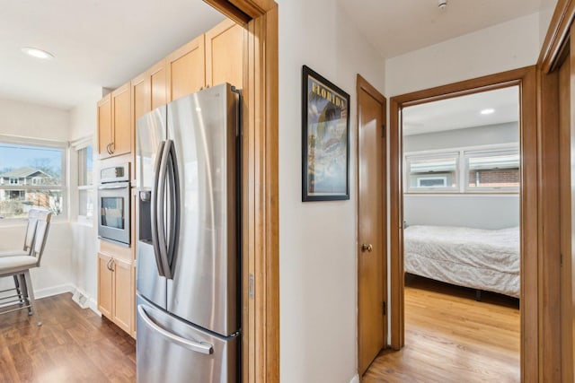 kitchen with visible vents, light brown cabinetry, wood finished floors, recessed lighting, and appliances with stainless steel finishes