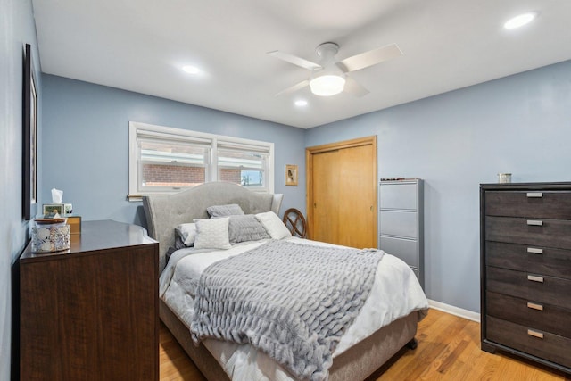 bedroom with recessed lighting, a closet, baseboards, and light wood-style flooring