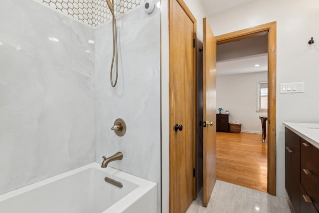 bathroom with shower / bathing tub combination, wood finished floors, and vanity