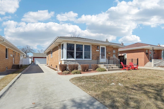 view of front of property with brick siding, a garage, and an outdoor structure