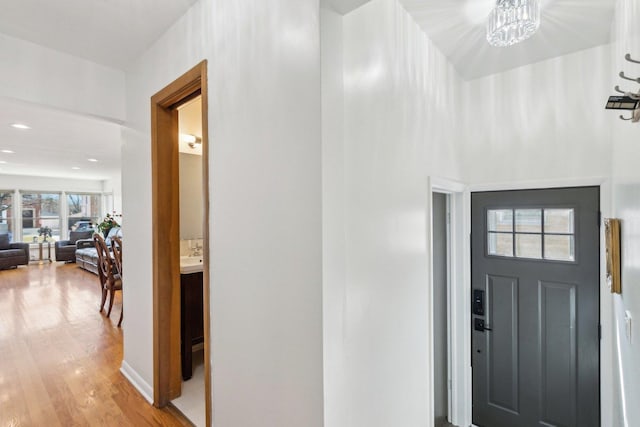 foyer featuring a chandelier and light wood-style flooring