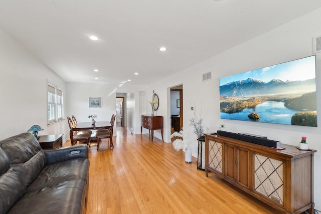 living room featuring light wood-type flooring, visible vents, and recessed lighting