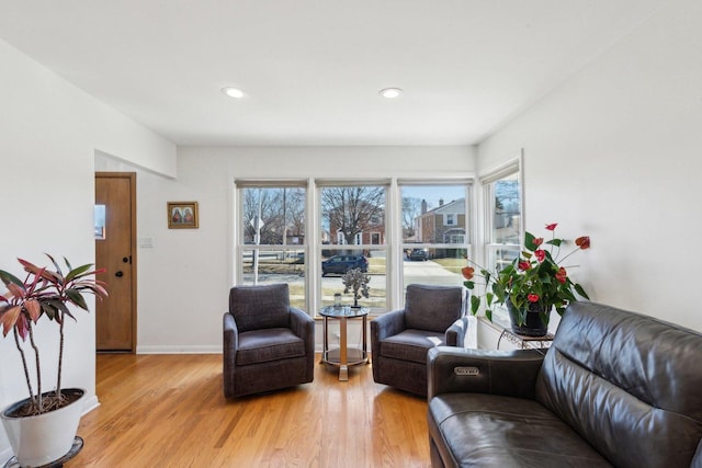 living area featuring recessed lighting, baseboards, and light wood-style floors