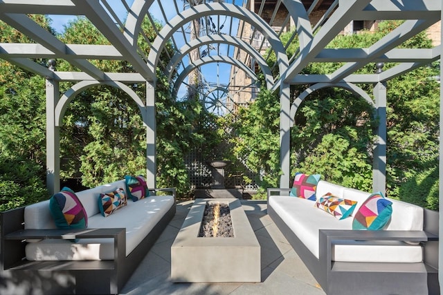 view of patio with an outdoor living space with a fire pit and a pergola