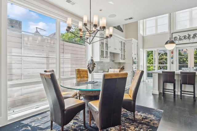 dining area with a notable chandelier, dark wood-style floors, visible vents, and french doors