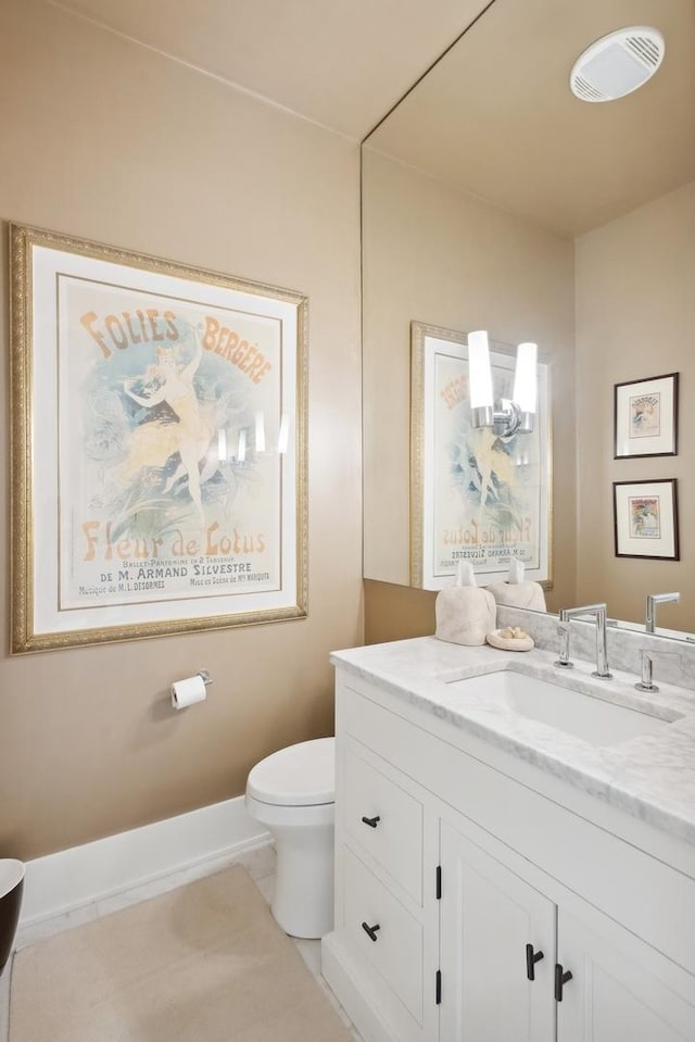 bathroom with tile patterned flooring, visible vents, baseboards, toilet, and vanity