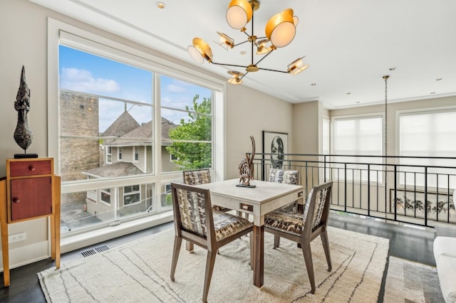 dining room featuring visible vents, an inviting chandelier, and a healthy amount of sunlight