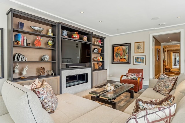 living area with recessed lighting, a fireplace, and built in shelves