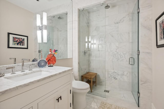 full bath with a marble finish shower, marble finish floor, toilet, and vanity