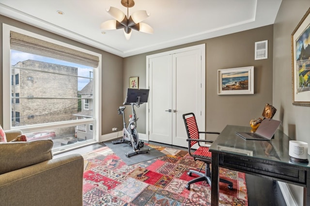 office area with wood finished floors, visible vents, baseboards, and ceiling fan