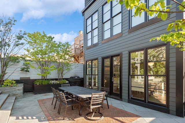 view of patio / terrace with outdoor dining space, fence, and grilling area