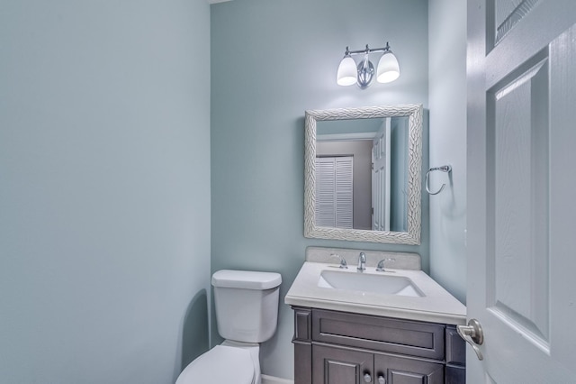 bathroom with toilet and vanity