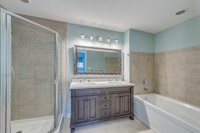 bathroom with a bath, a shower stall, double vanity, and a sink