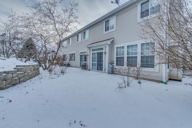 snow covered property featuring cooling unit