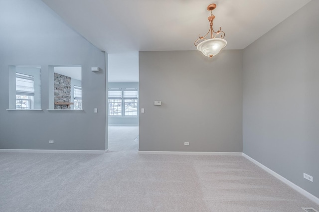 spare room with carpet and baseboards