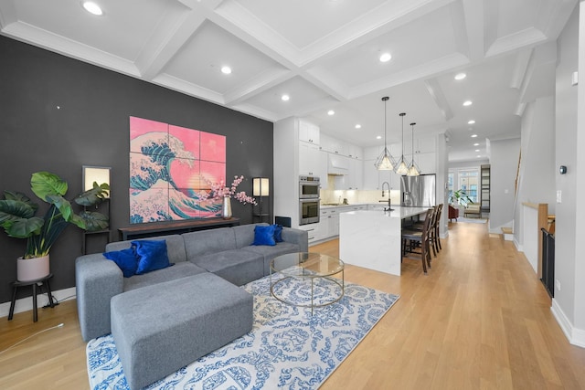 living room featuring beamed ceiling, coffered ceiling, recessed lighting, light wood finished floors, and baseboards