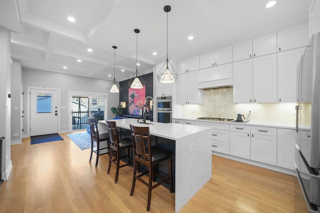 kitchen featuring white cabinets, light wood-style floors, and stainless steel appliances