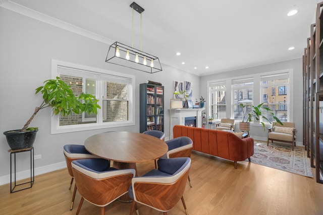 dining area with recessed lighting, light wood-type flooring, baseboards, and a fireplace