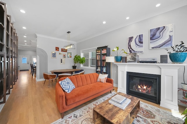 living area with recessed lighting, plenty of natural light, light wood-style flooring, and ornamental molding