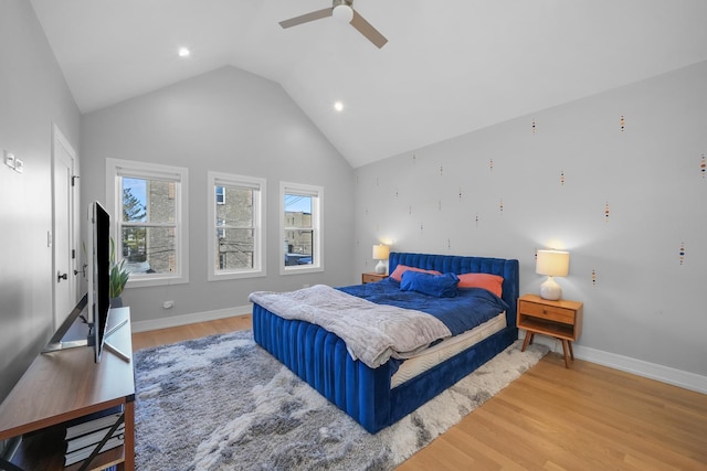 bedroom with ceiling fan, high vaulted ceiling, light wood-type flooring, and baseboards