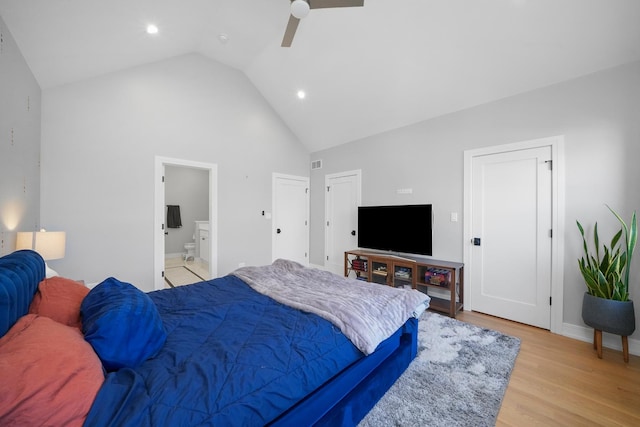 bedroom with light wood-type flooring, visible vents, high vaulted ceiling, ensuite bath, and ceiling fan