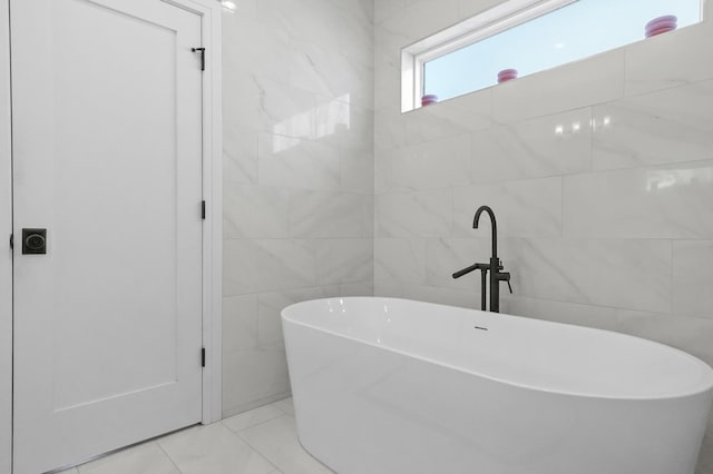 full bathroom featuring a soaking tub and tile walls