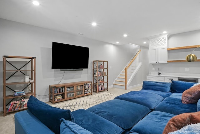 living area with recessed lighting, wet bar, light colored carpet, and stairs