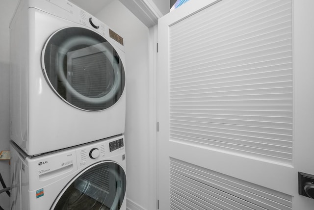 washroom featuring laundry area and stacked washer / drying machine