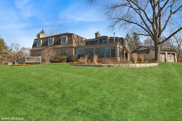 back of property featuring a lawn, mansard roof, and a chimney