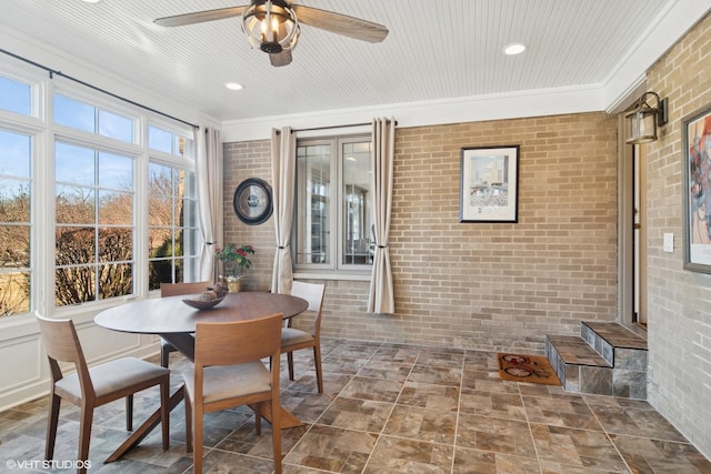 sunroom featuring a ceiling fan