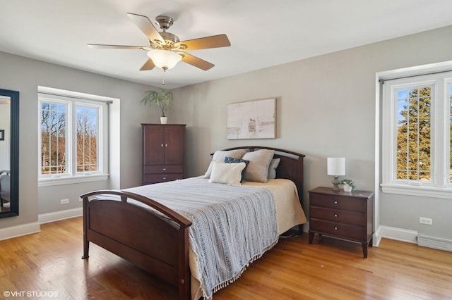 bedroom with ceiling fan, light wood-type flooring, and baseboards