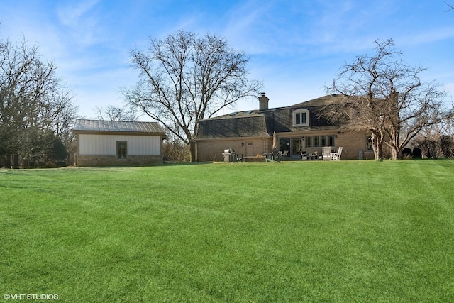 view of yard with a patio and an outdoor structure