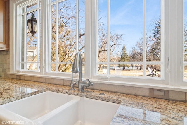 room details with light stone counters and a sink