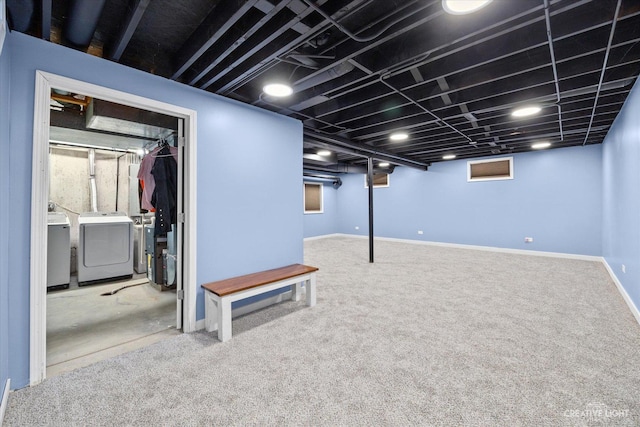 finished basement featuring carpet, washing machine and dryer, and baseboards