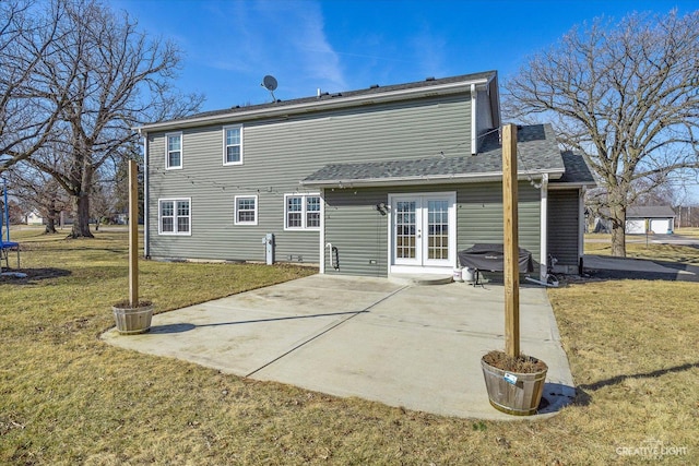 rear view of house with a patio area, french doors, and a yard