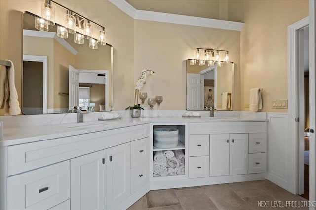 full bathroom with a sink, ornamental molding, and double vanity