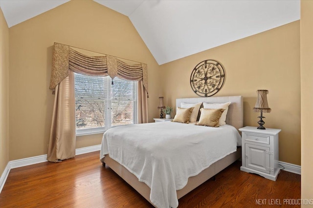 bedroom featuring dark wood-style floors, baseboards, and vaulted ceiling